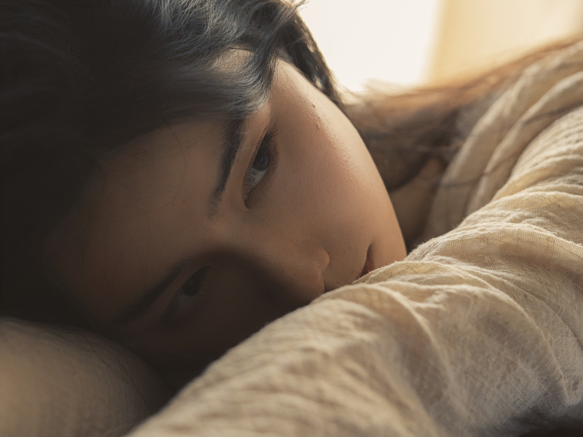 Soft portrait of a woman resting in warm natural light
