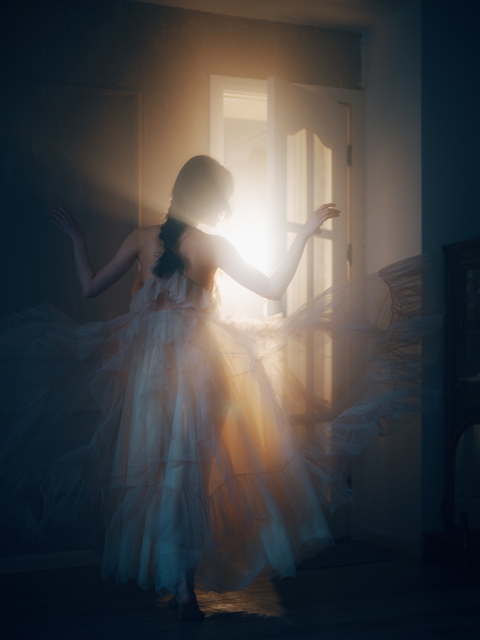 Backlit portrait in flowing dress