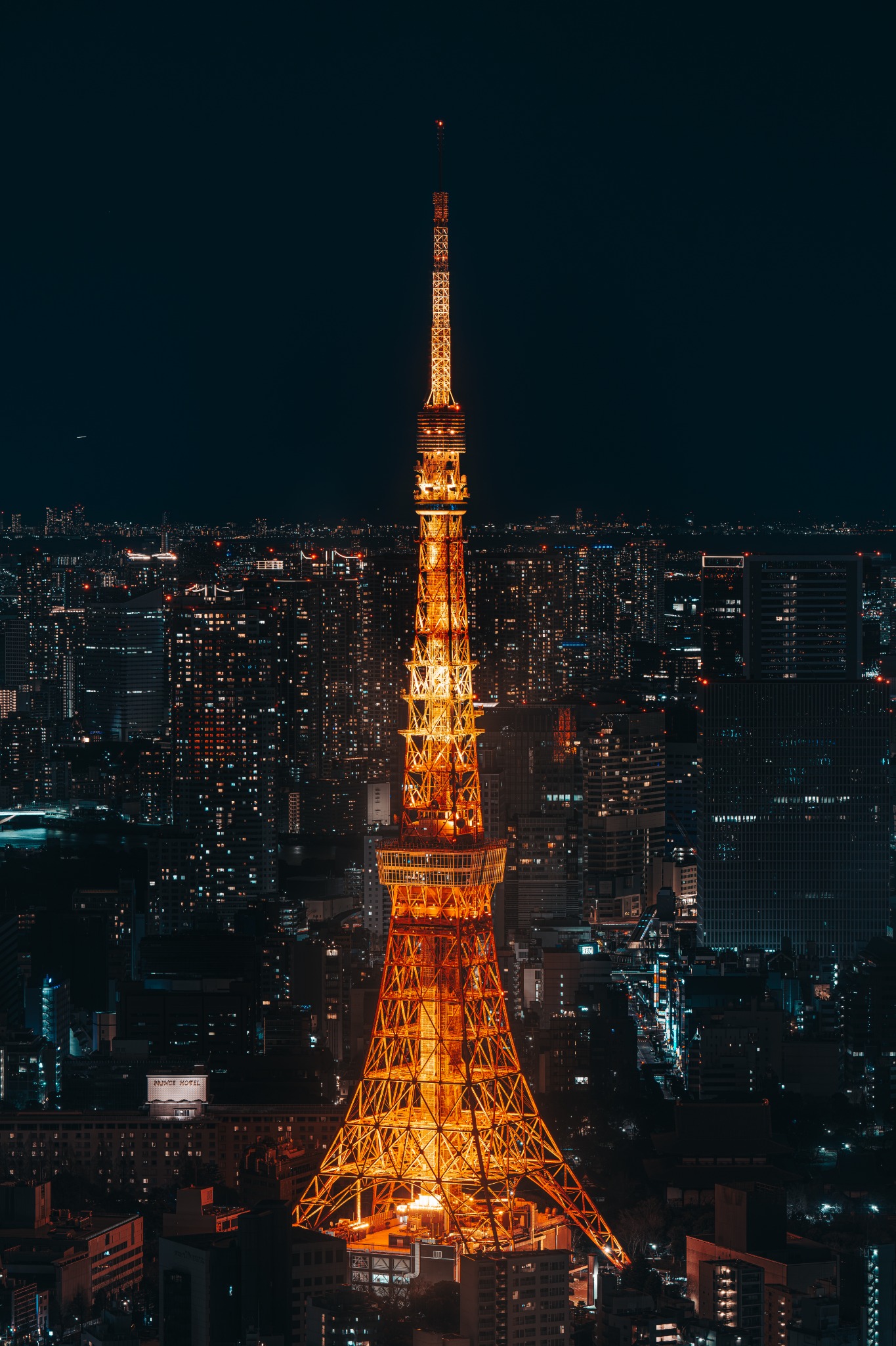 Tokyo Tower glowing over the city skyline at night